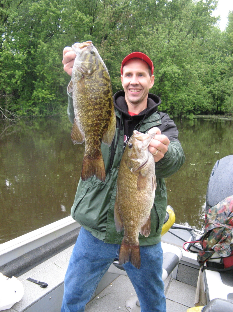 Excited angler with two very large largemouth bass.