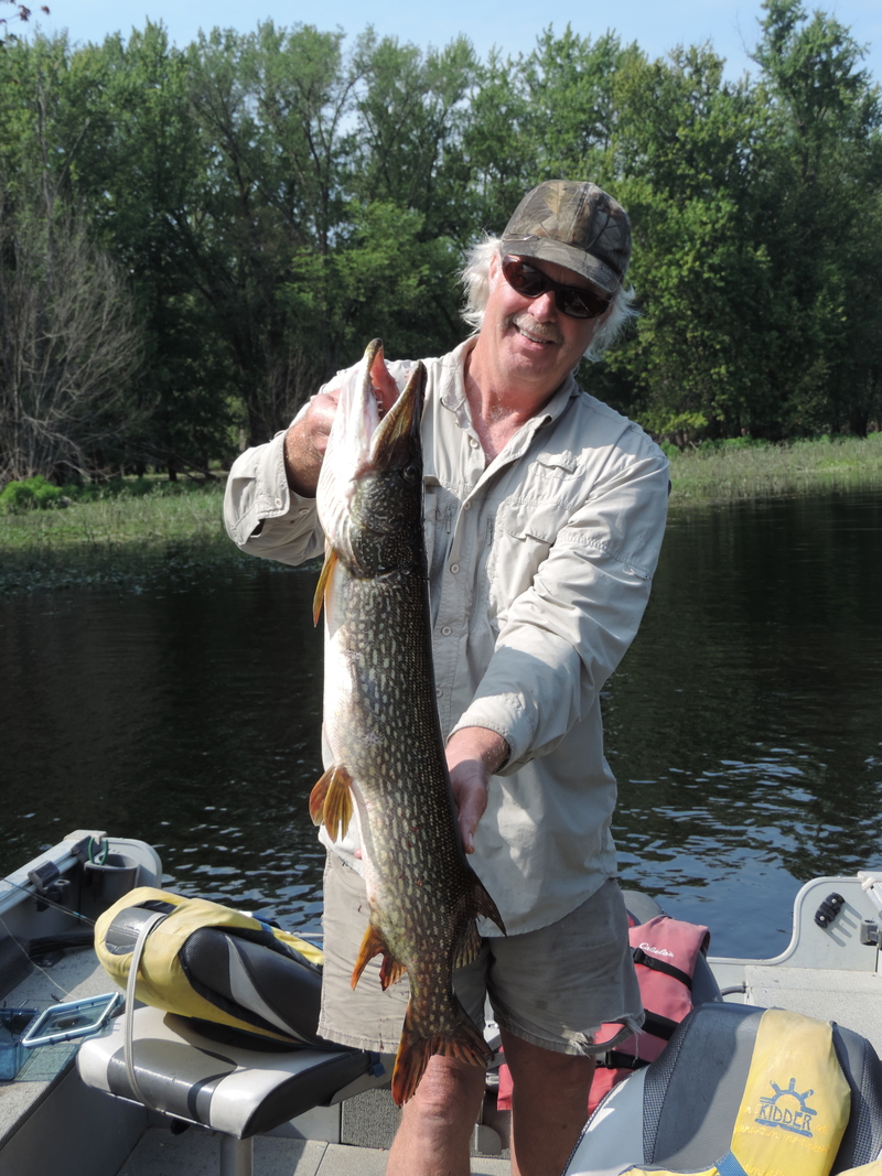 Excited angler with a large Northern Pike.